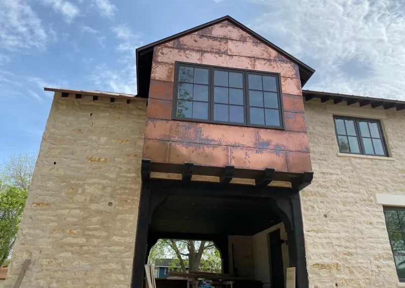 Copper metal panel facade on a stone building for Skylight Installation in Sergeant Bluff