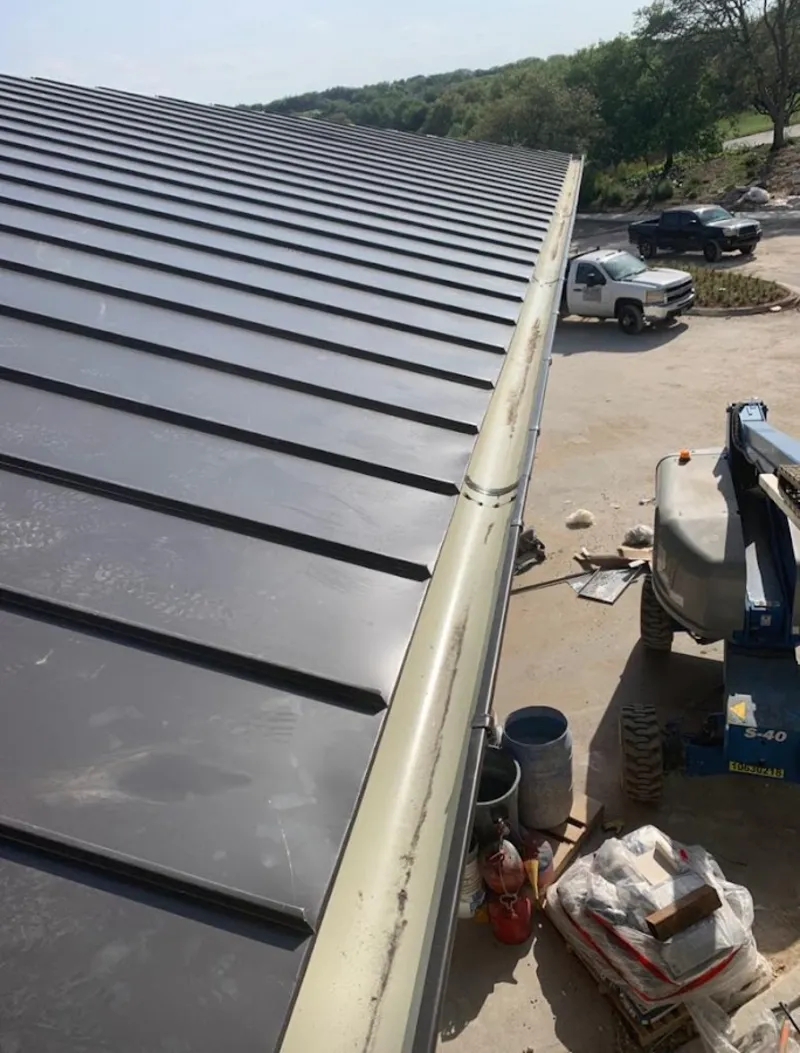 Standing seam panel and gutter detail on a metal roofing jobsite in Sergeant Bluff